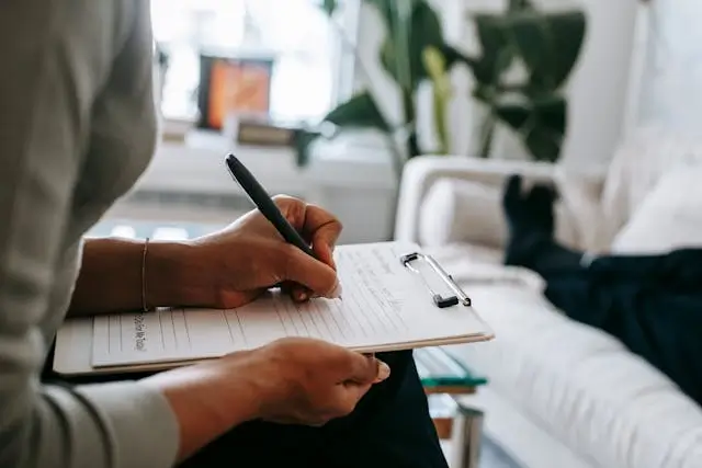 Person writing notes on a pad