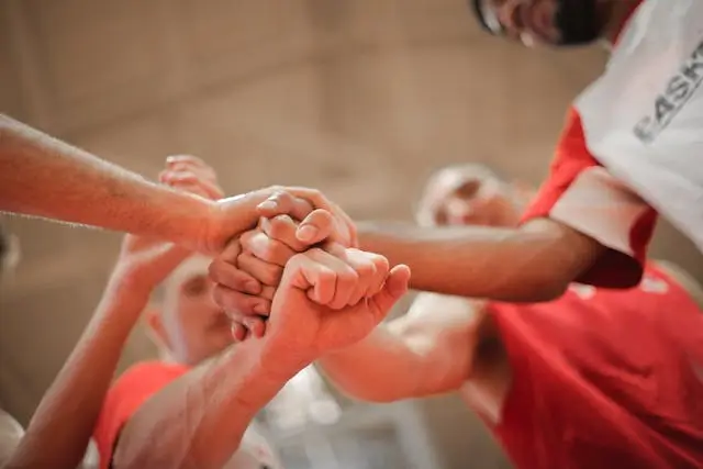 People's hands placed on top of each other